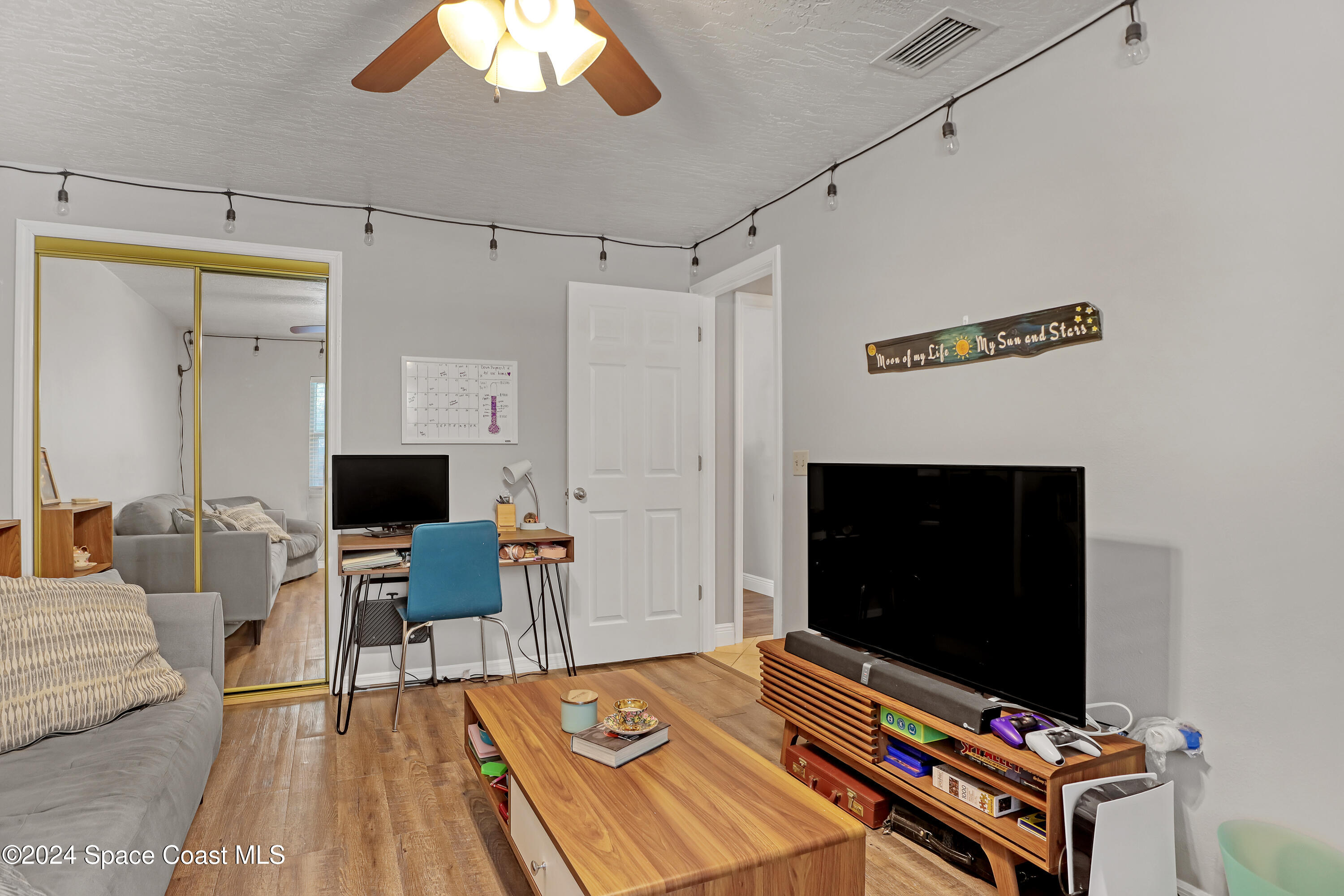3865 Corey Road Malabar, FL 32950 - Photo 38 of 72 a living room with furniture and a flat screen tv