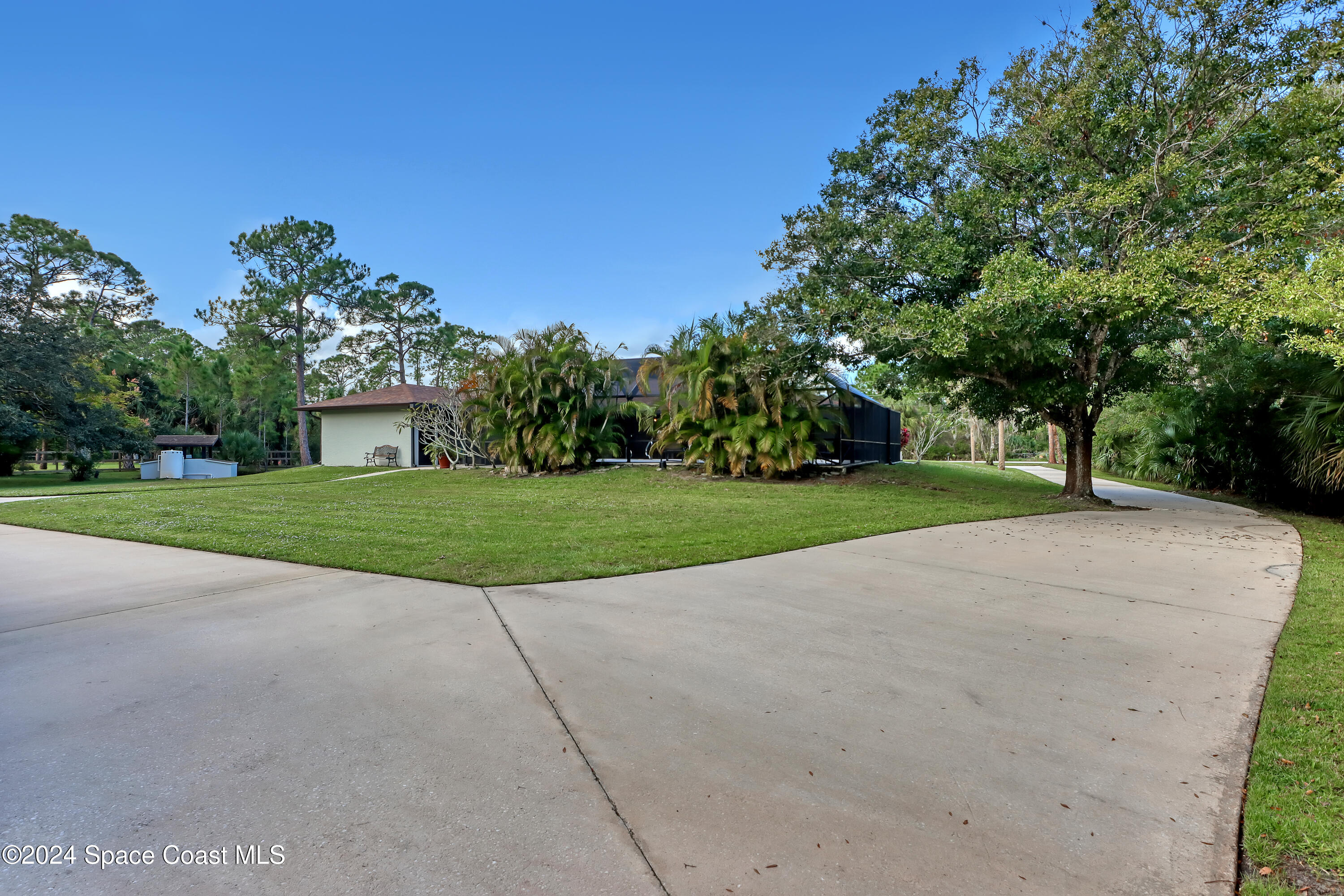3865 Corey Road Malabar, FL 32950 - Photo 48 of 72 a view of a house with a big yard and large trees