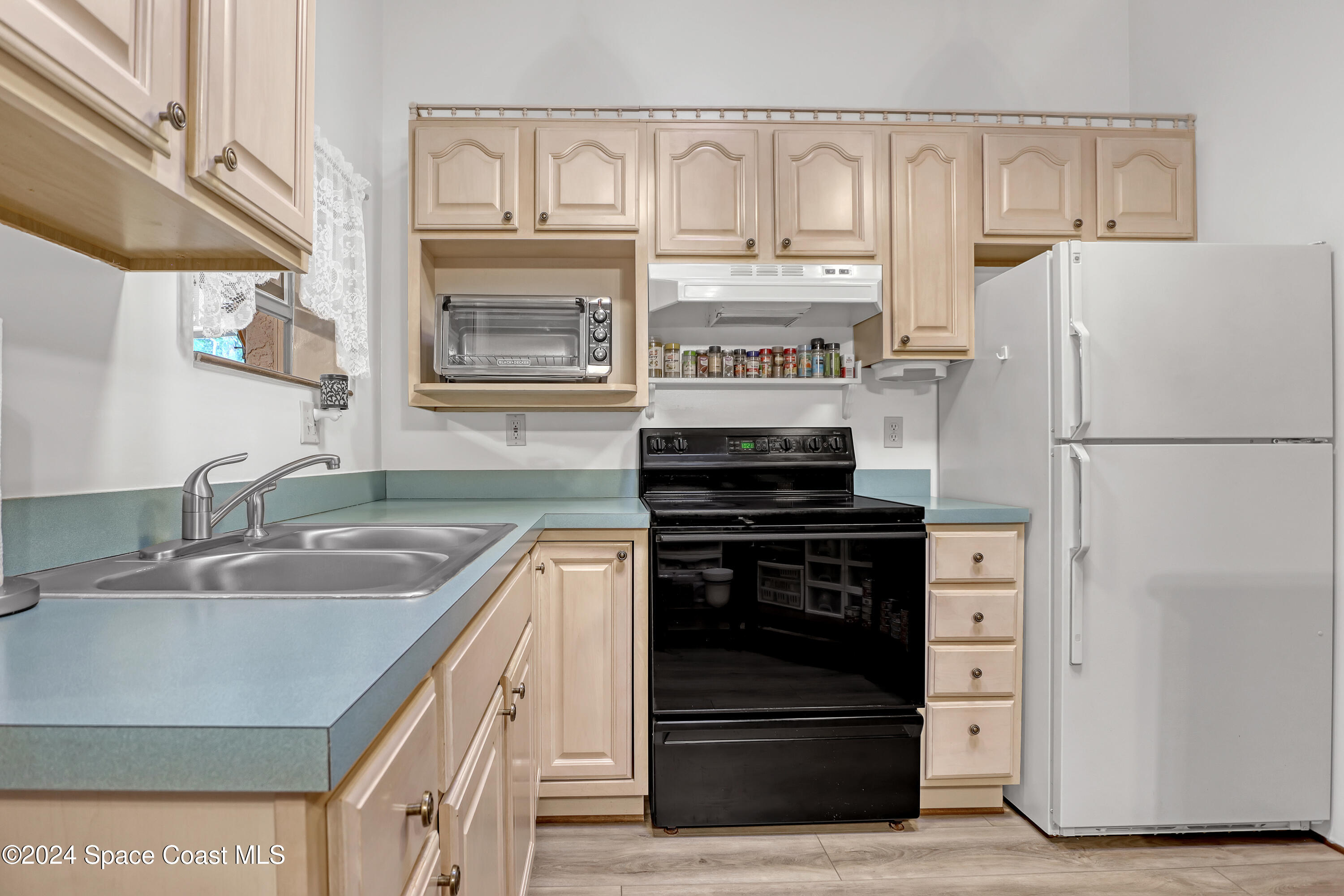 3865 Corey Road Malabar, FL 32950 - Photo 55 of 72 a kitchen with stainless steel appliances granite countertop a refrigerator and a sink