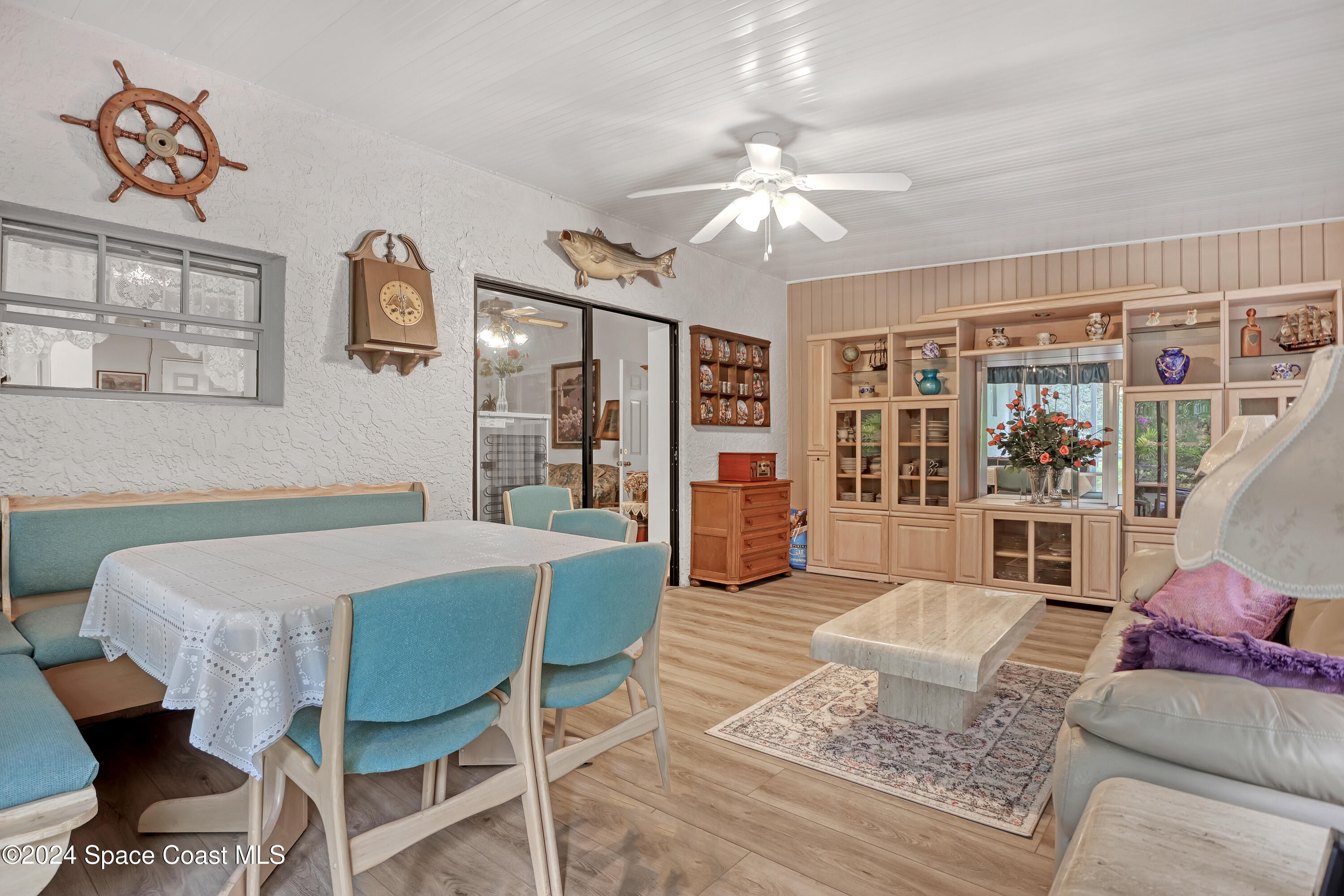 3865 Corey Road Malabar, FL 32950 - Photo 58 of 72 a living room with furniture a chandelier and a dining table