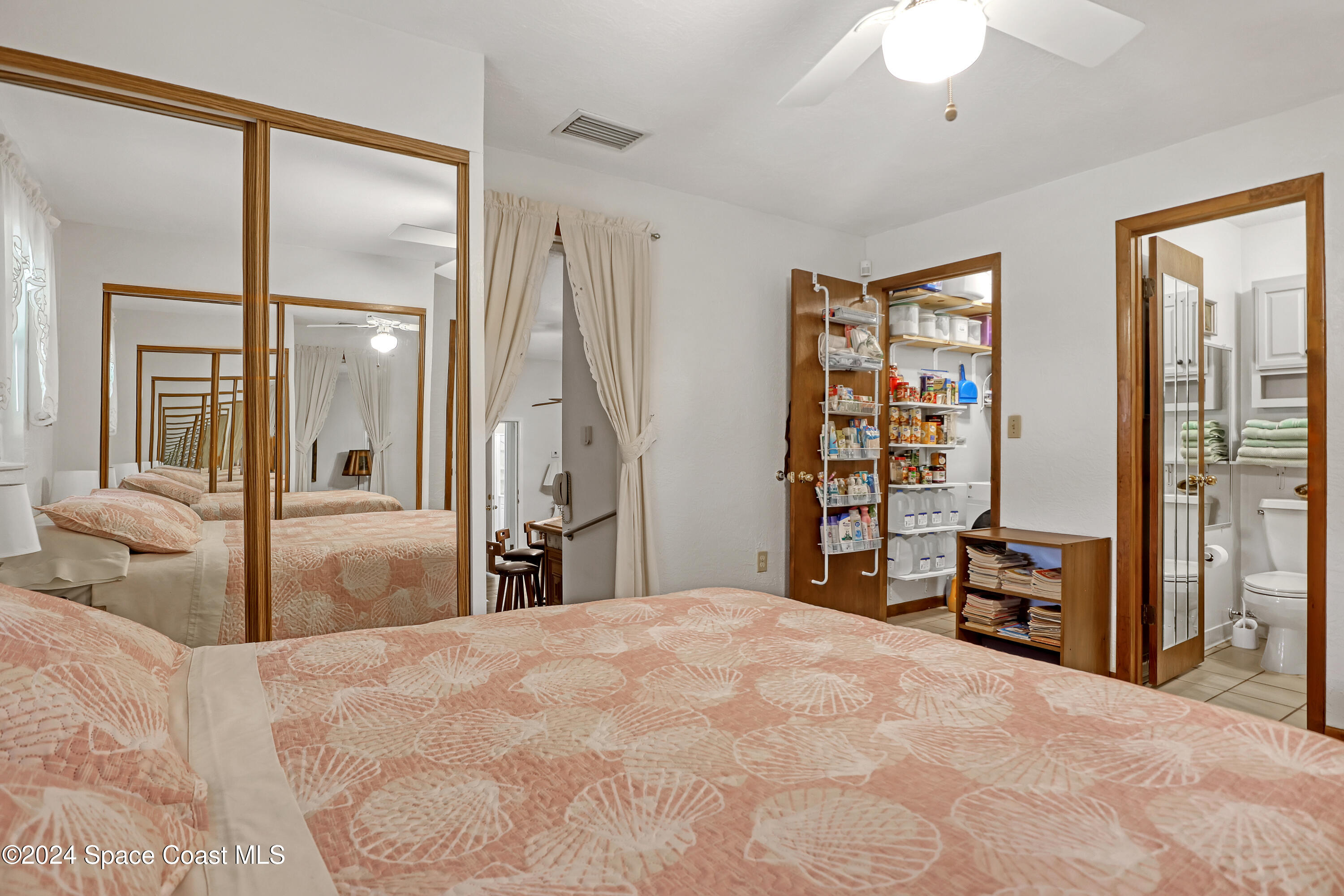 3865 Corey Road Malabar, FL 32950 - Photo 64 of 72 a bedroom with a large bed and a large mirror