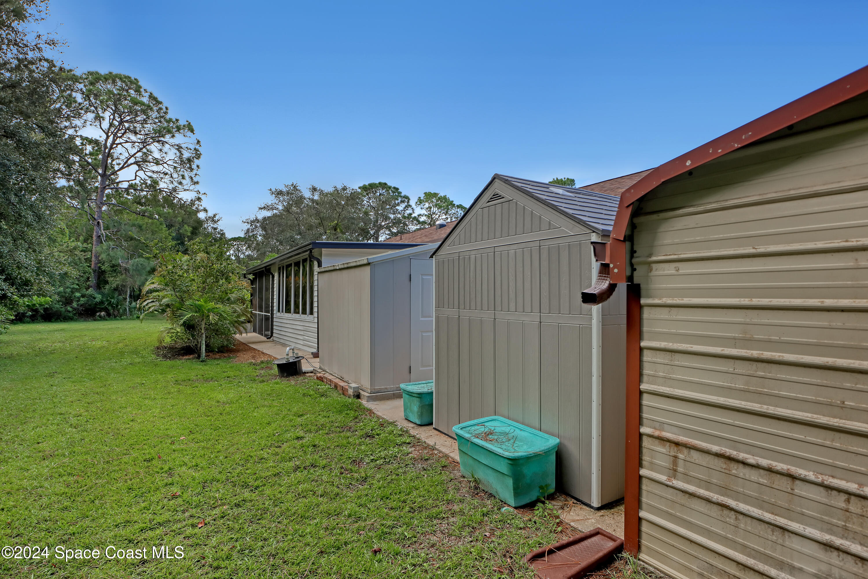 3865 Corey Road Malabar, FL 32950 - Photo 68 of 72 a view of a backyard with plants and a patio