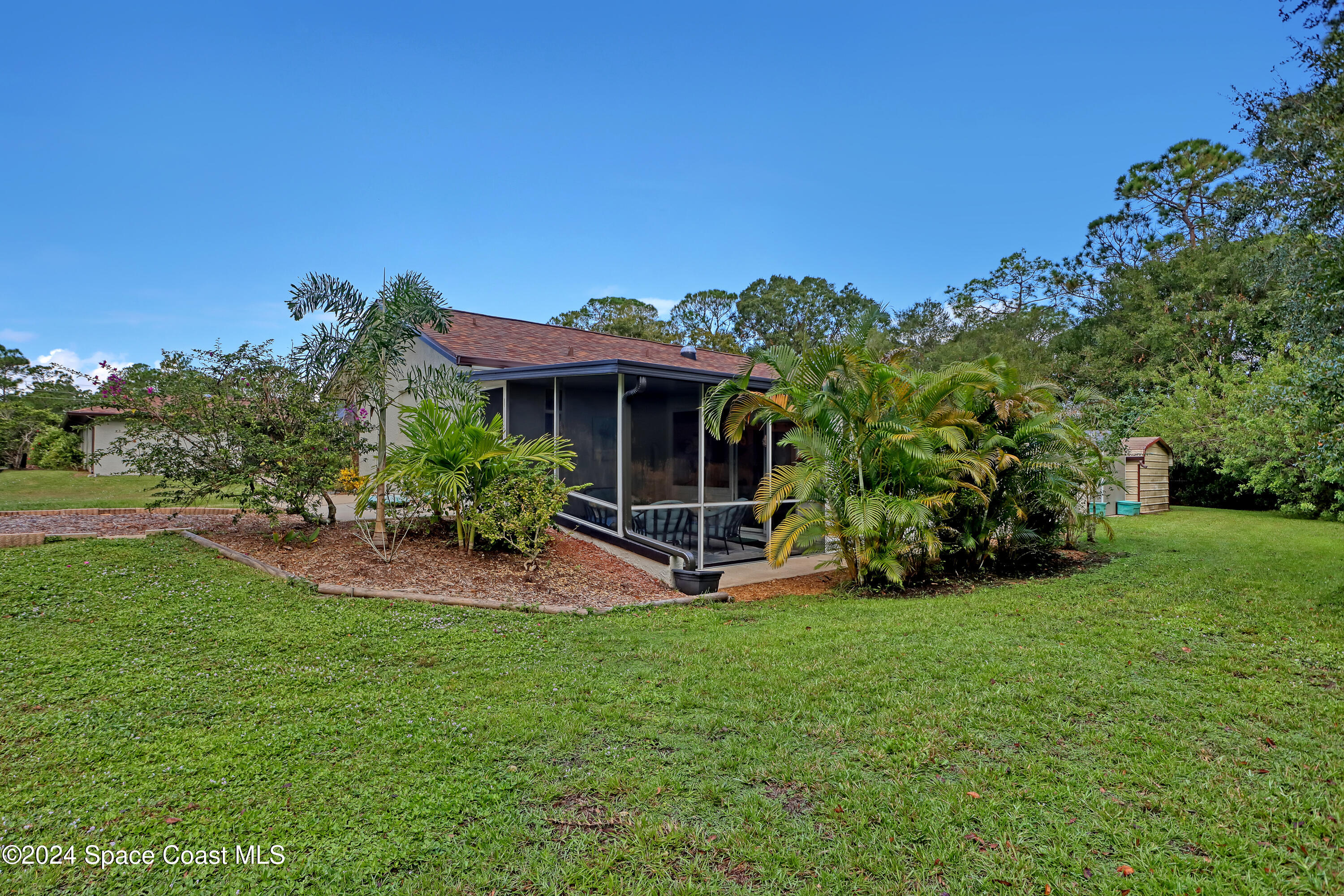 3865 Corey Road Malabar, FL 32950 - Photo 70 of 72 a view of a house with a yard and sitting area