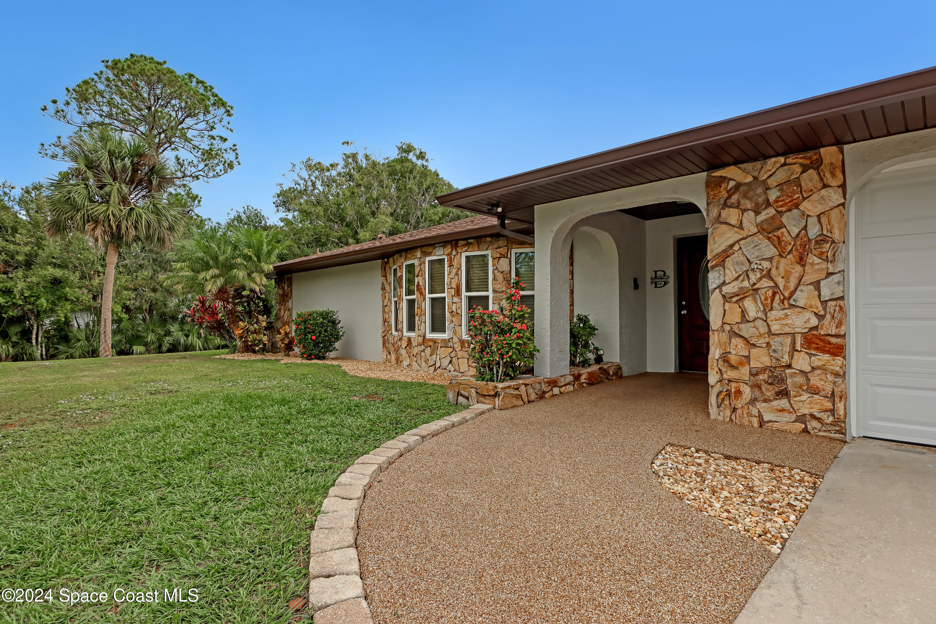 3865 Corey Road Malabar, FL 32950 - Photo 8 of 72 a front view of a house with garden