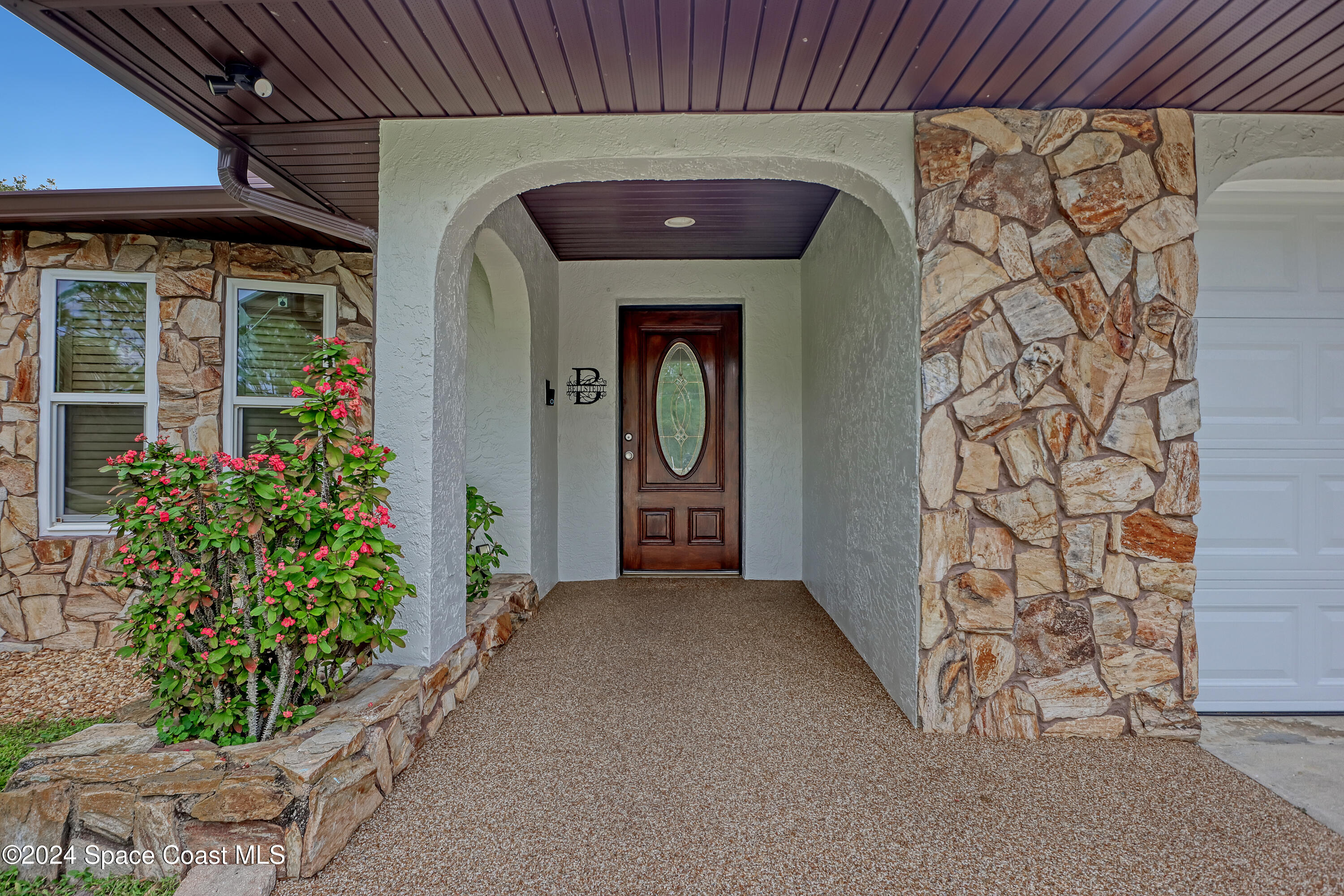3865 Corey Road Malabar, FL 32950 - Photo 9 of 72 a front view of a house with a porch