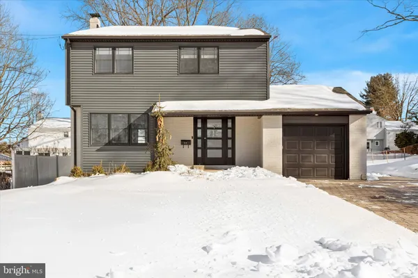 a view of a house with snow on the road