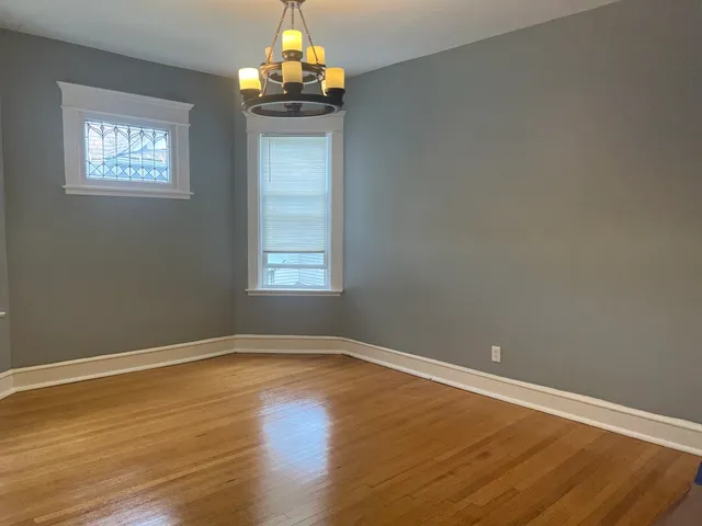 a view of wooden floor and chandelier in a room