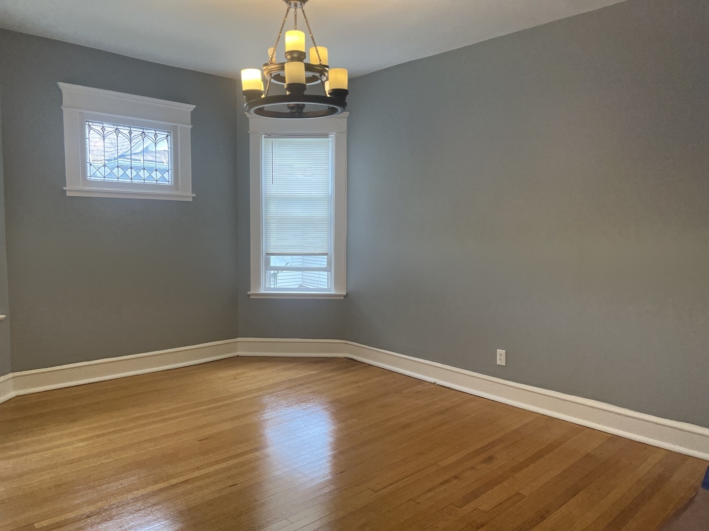208 North Waller Avenue, Unit 2N Chicago, IL 60644 - Photo 2 of 10 a view of wooden floor and chandelier in a room