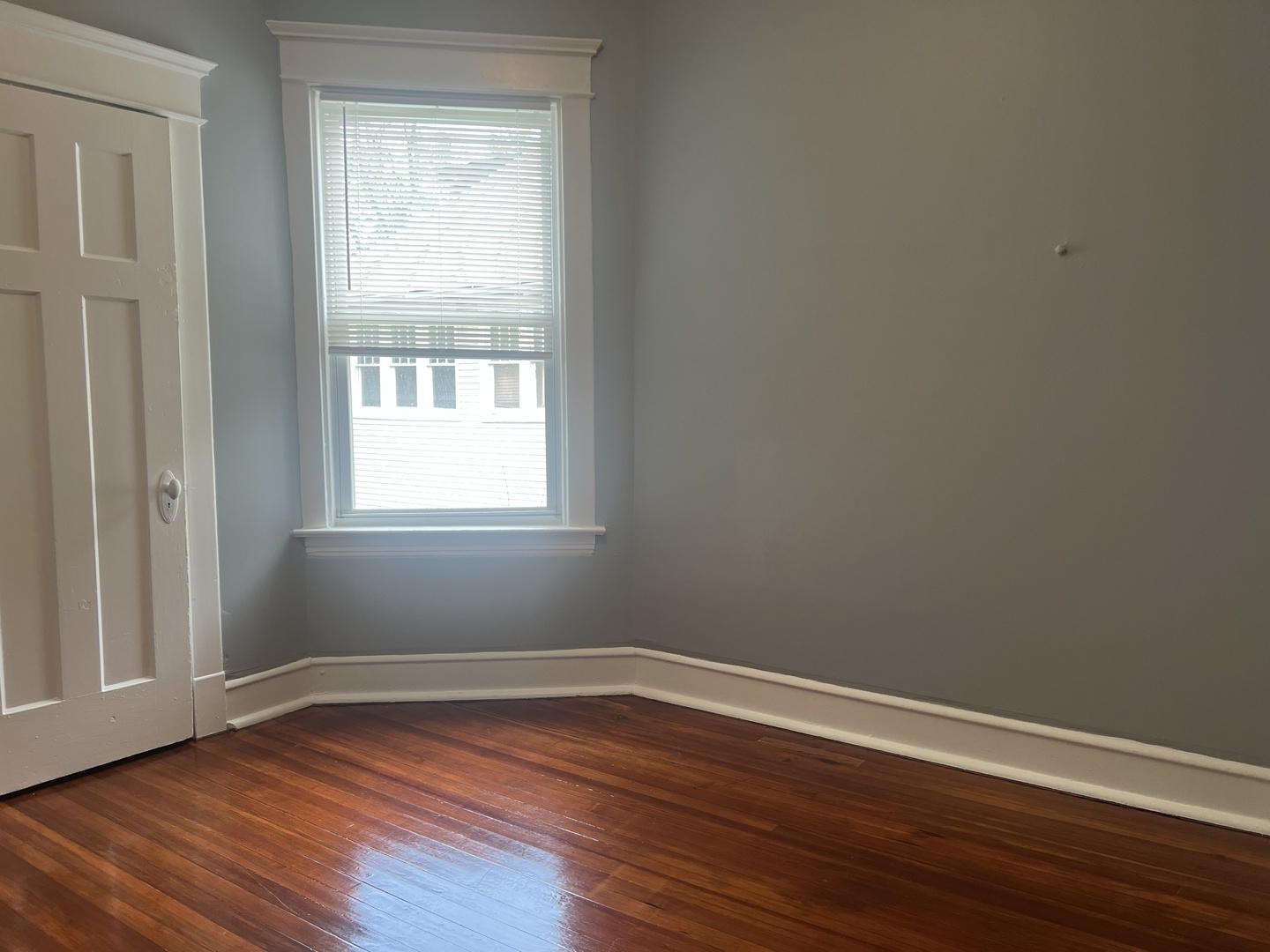 208 North Waller Avenue, Unit 2N Chicago, IL 60644 - Photo 6 of 10 a view of a room with wooden floor and windows in it