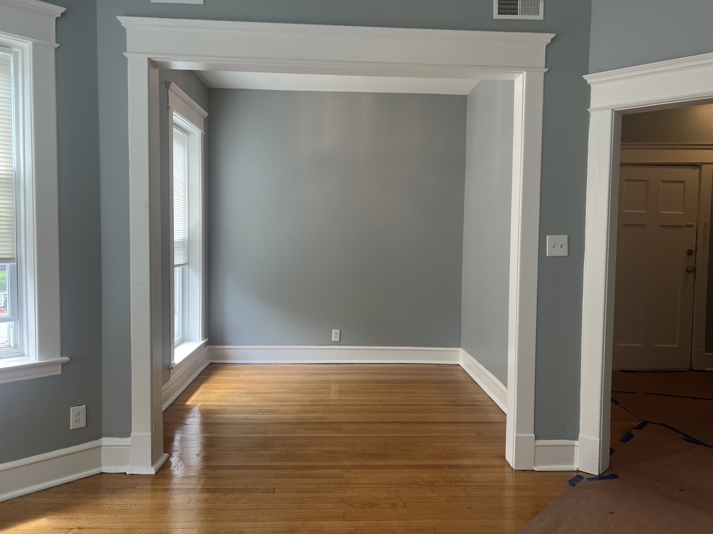 208 North Waller Avenue, Unit 2N Chicago, IL 60644 - Photo 8 of 10 a view of an empty room with wooden floor and a window