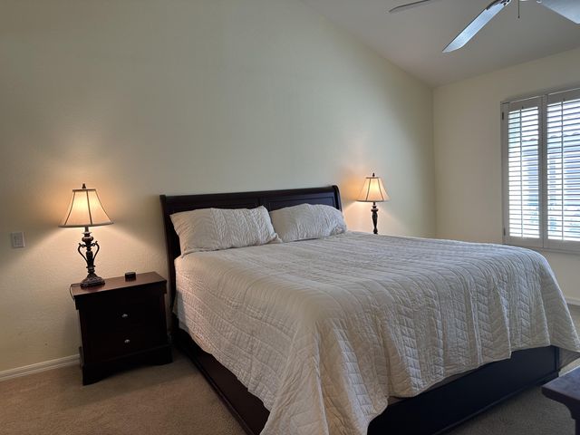 a bedroom with a bed and a lamp