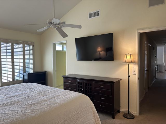 a bedroom with a bed and a flat screen tv