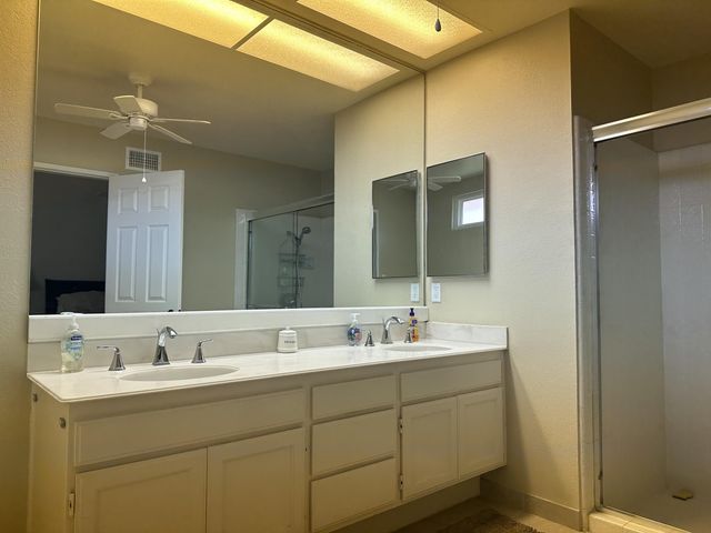 a bathroom with a double vanity sink and mirror