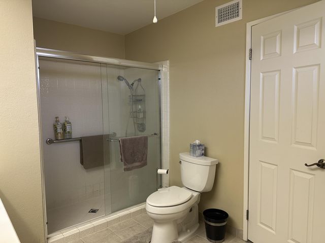a bathroom with a toilet and a shower