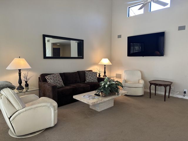a living room with furniture and a lamp
