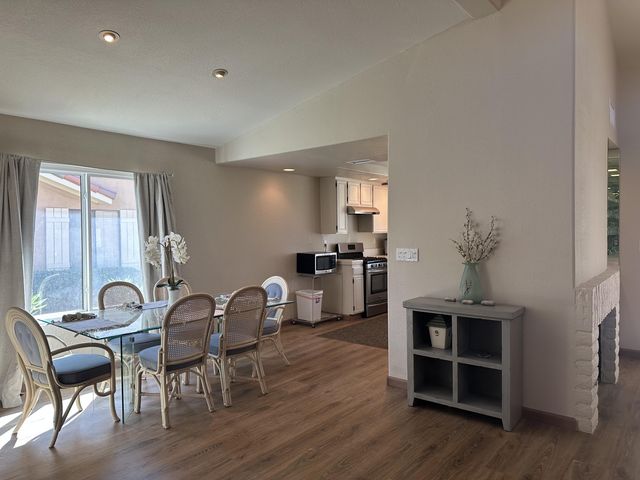 a dining room with furniture and wooden floor