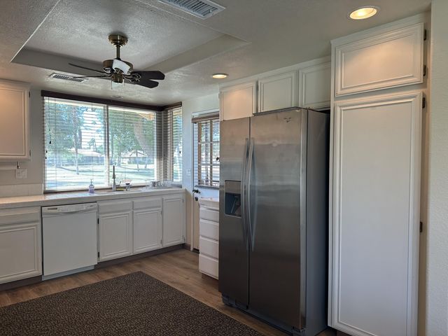 a large kitchen with a refrigerator and a sink