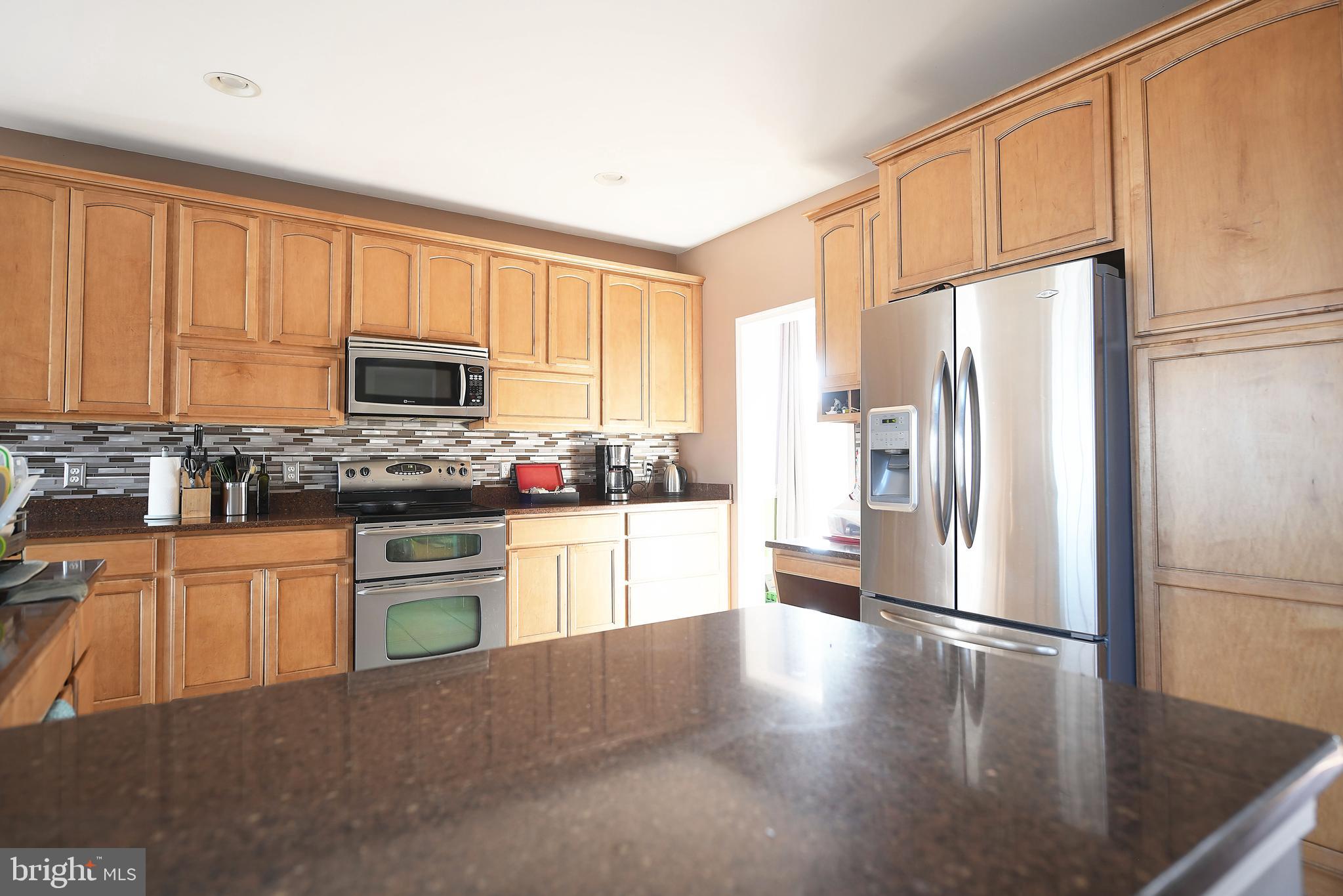 1611 Van Bibber Road Edgewood, MD 21040 - Photo 7 of 23 a kitchen with granite countertop a refrigerator stove top oven and sink