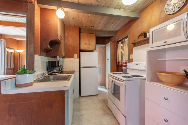 a kitchen with a sink stove and refrigerator