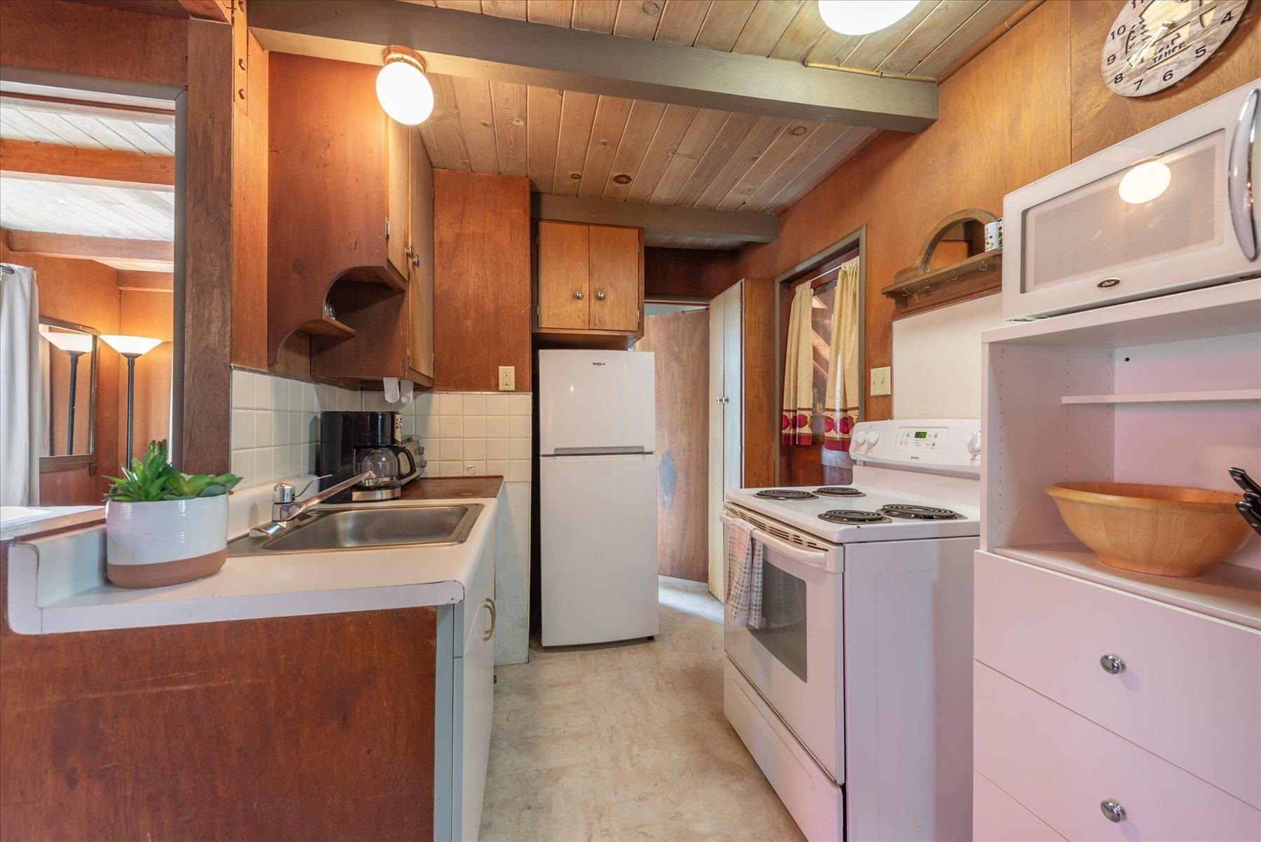 265 Old County Road Carnelian Bay, CA 96140 - Photo 18 of 28 a kitchen with a sink stove and refrigerator
