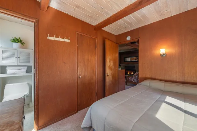 a bedroom with a bed and a bathroom