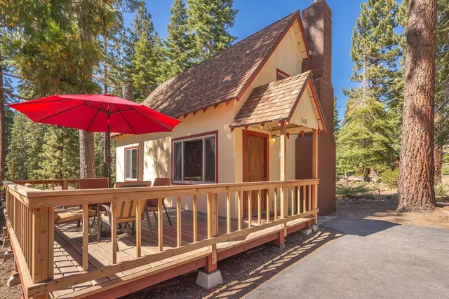 a view of a house with a yard and furniture