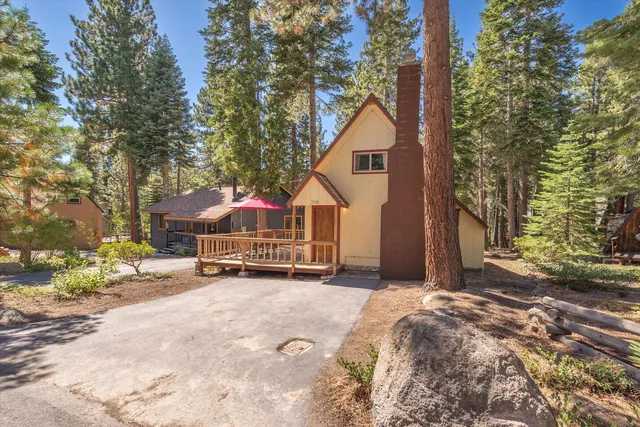 a view of a house with a yard and covered with snow