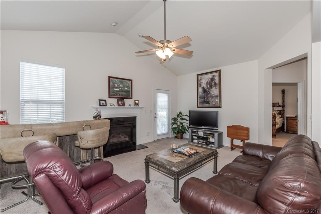 242 Garnet Court Fort Mill, SC 29708 - Photo 14 of 22 a living room with furniture a fireplace and a window