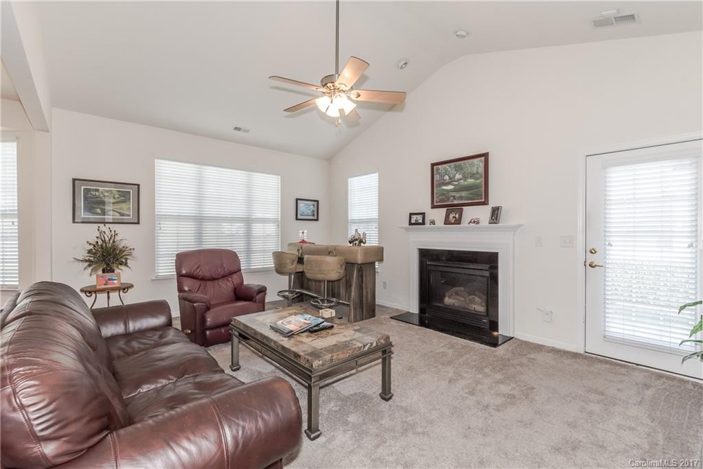 242 Garnet Court Fort Mill, SC 29708 - Photo 15 of 22 a living room with furniture a fireplace and a window