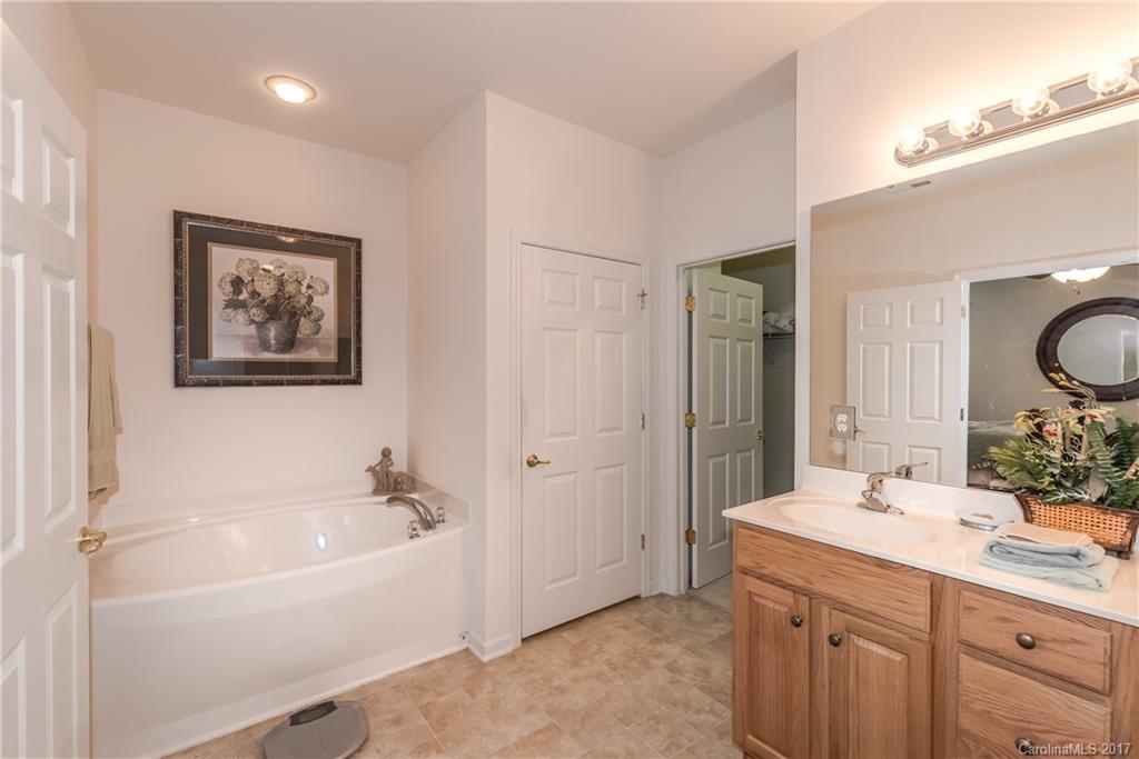 242 Garnet Court Fort Mill, SC 29708 - Photo 17 of 22 a bathroom with a tub a sink and mirror