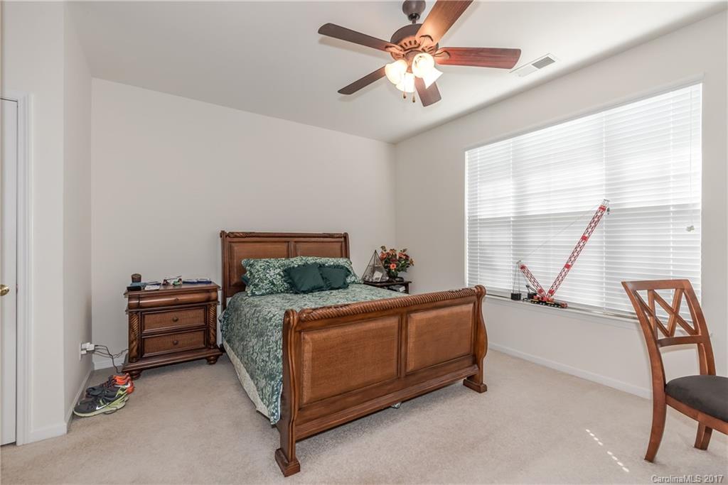 242 Garnet Court Fort Mill, SC 29708 - Photo 19 of 22 a bed room with a bed and a chair