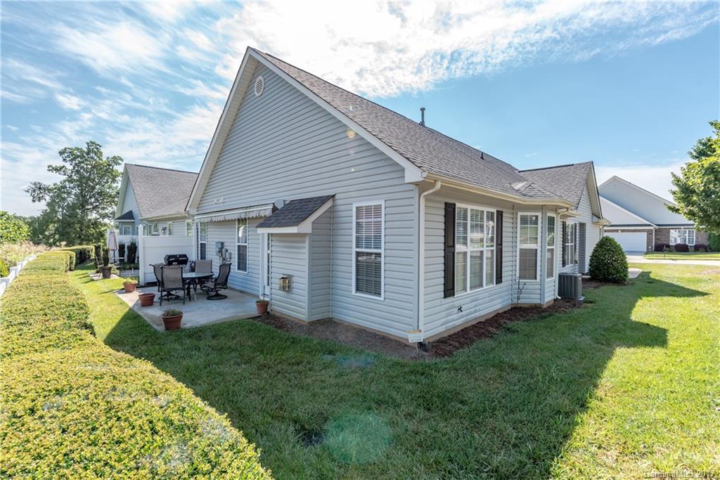 242 Garnet Court Fort Mill, SC 29708 - Photo 22 of 22 a view of a house with backyard sitting area and garden