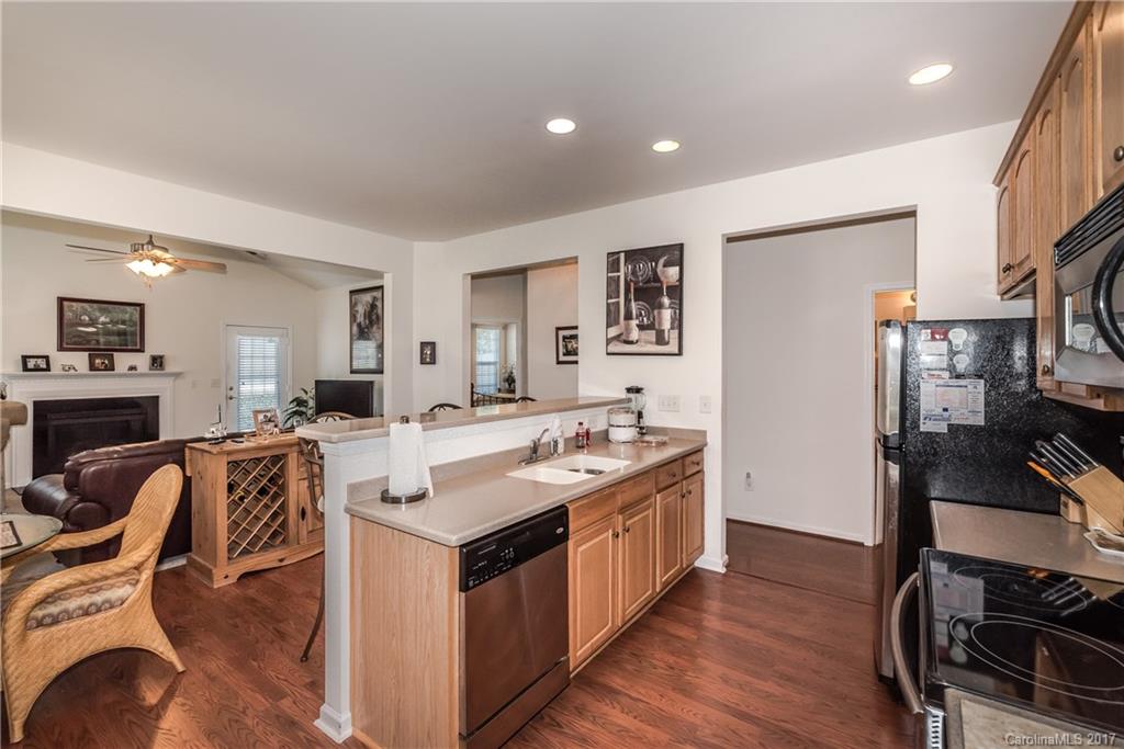 242 Garnet Court Fort Mill, SC 29708 - Photo 10 of 22 a kitchen with stainless steel appliances granite countertop a sink stove and wooden floor