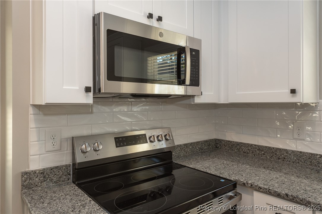 229 August Lane Raeford, NC 28376 - Photo 12 of 39 a kitchen with a stove and a microwave