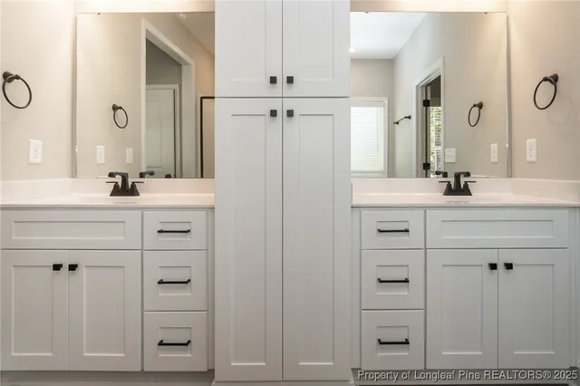 a bathroom with a sink vanity granite and a mirror