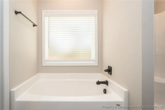 a white bath tub sitting next to a window