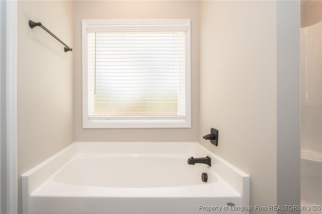 229 August Lane Raeford, NC 28376 - Photo 21 of 39 a white bath tub sitting next to a window