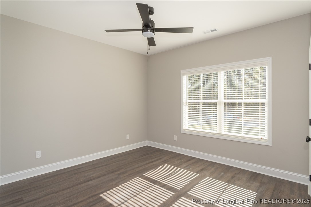229 August Lane Raeford, NC 28376 - Photo 23 of 39 a view of an empty room with a window and wooden floor