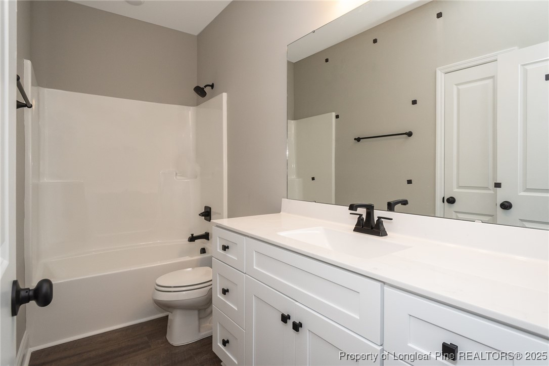 229 August Lane Raeford, NC 28376 - Photo 26 of 39 a bathroom with a sink a toilet and a mirror