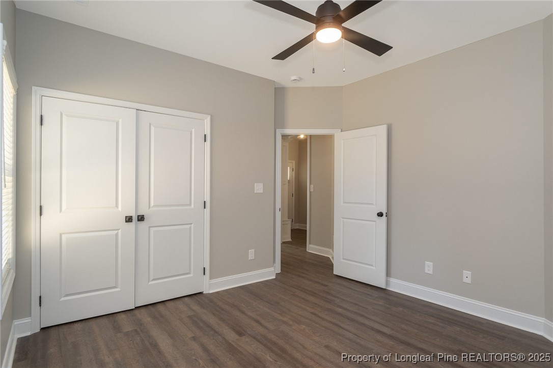 229 August Lane Raeford, NC 28376 - Photo 29 of 39 an empty room with wooden floor closet and windows