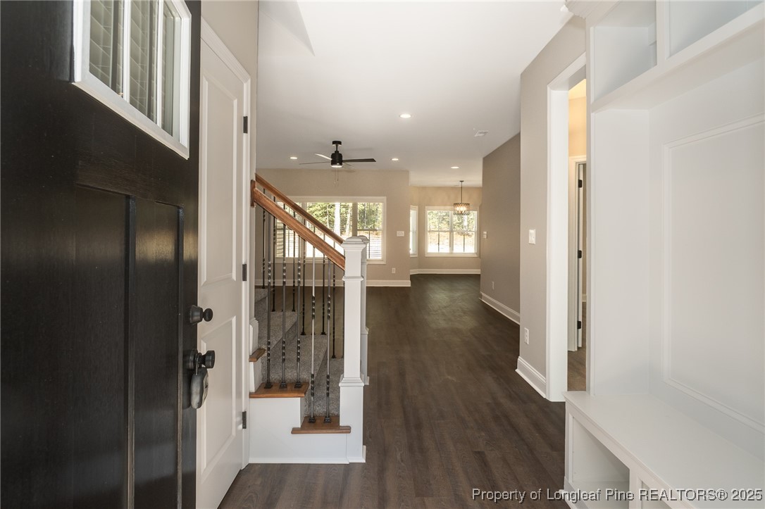 229 August Lane Raeford, NC 28376 - Photo 3 of 39 a view of a hallway with wooden floor and staircase