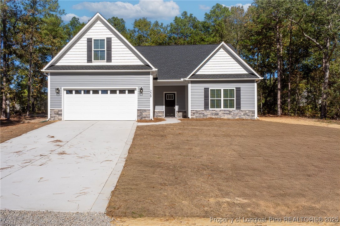 229 August Lane Raeford, NC 28376 - Photo 35 of 39 a front view of a house with a yard and garage