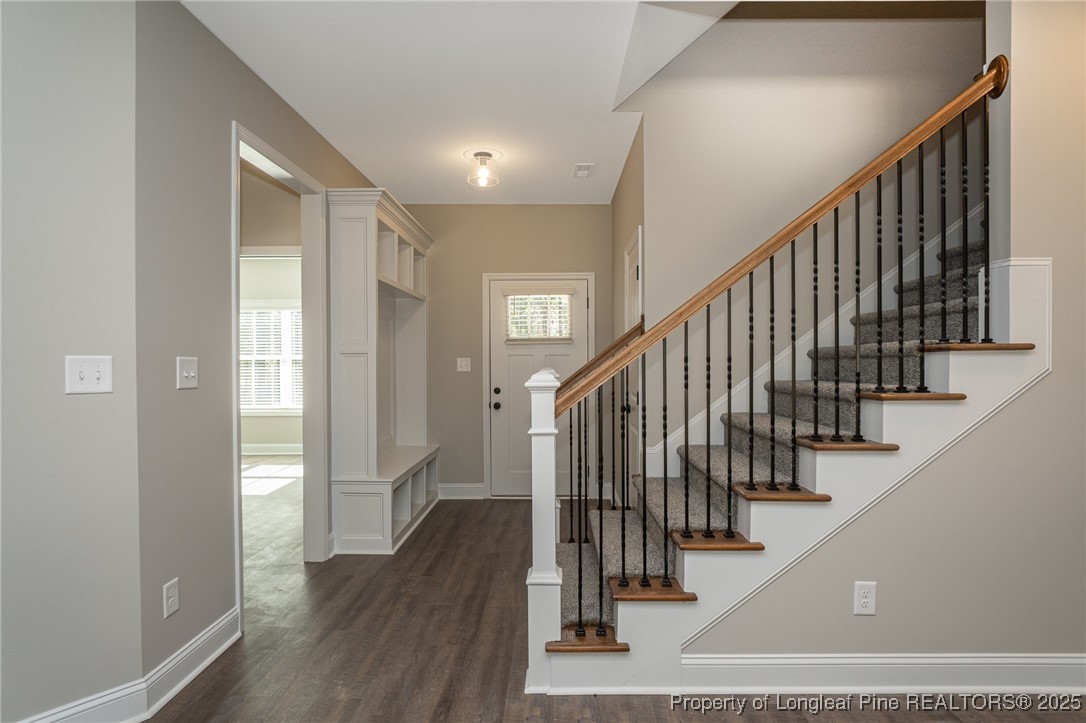 229 August Lane Raeford, NC 28376 - Photo 4 of 39 a view of staircase with wooden floor and stairs