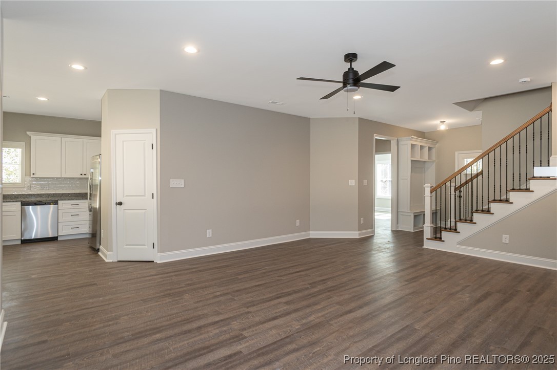 229 August Lane Raeford, NC 28376 - Photo 7 of 39 a view of an empty room with wooden floor and a ceiling fan