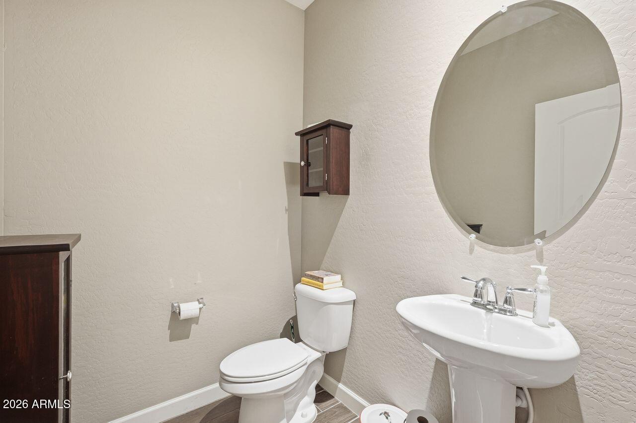 23602 West Ripple Road Buckeye, AZ 85326 - Photo 20 of 38 a bathroom with a toilet sink and mirror