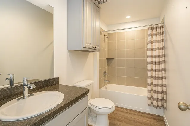 a bathroom with a sink toilet and shower