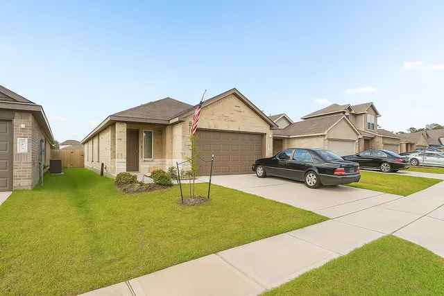 a view of a house with patio and a yard