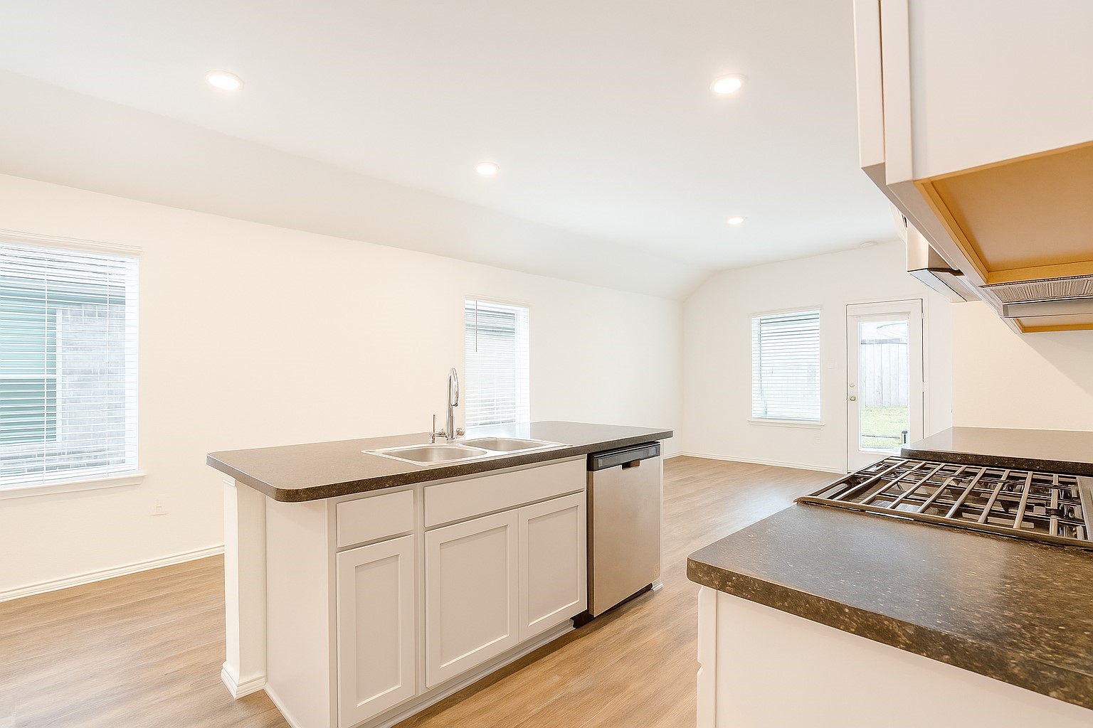 5611 Simcrest Grove Drive Spring, TX 77373 - Photo 9 of 18 a kitchen with a sink stove and cabinets