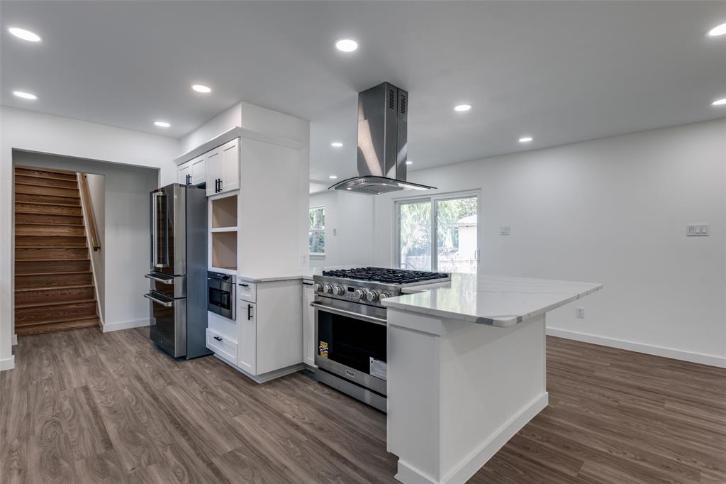11341 Gatewood Place Dallas, TX 75218 - Photo 15 of 29 a kitchen with stainless steel appliances a stove refrigerator and wooden floor