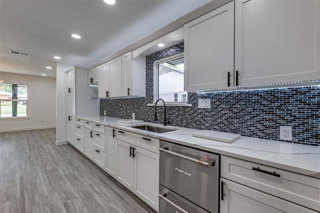 11341 Gatewood Place Dallas, TX 75218 - Photo 16 of 29 a kitchen with stainless steel appliances kitchen island granite countertop a sink and cabinets